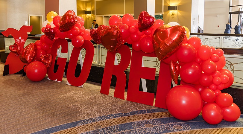 Go Red spelled out in large red letters and balloons.